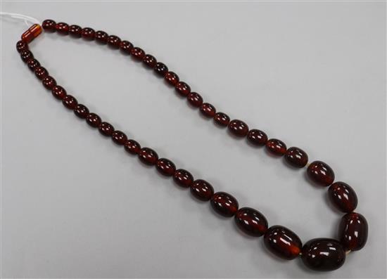 A single strand simulated cherry amber bead necklace, 58cm.